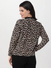 Woman wearing a leopard print blouse against a white background