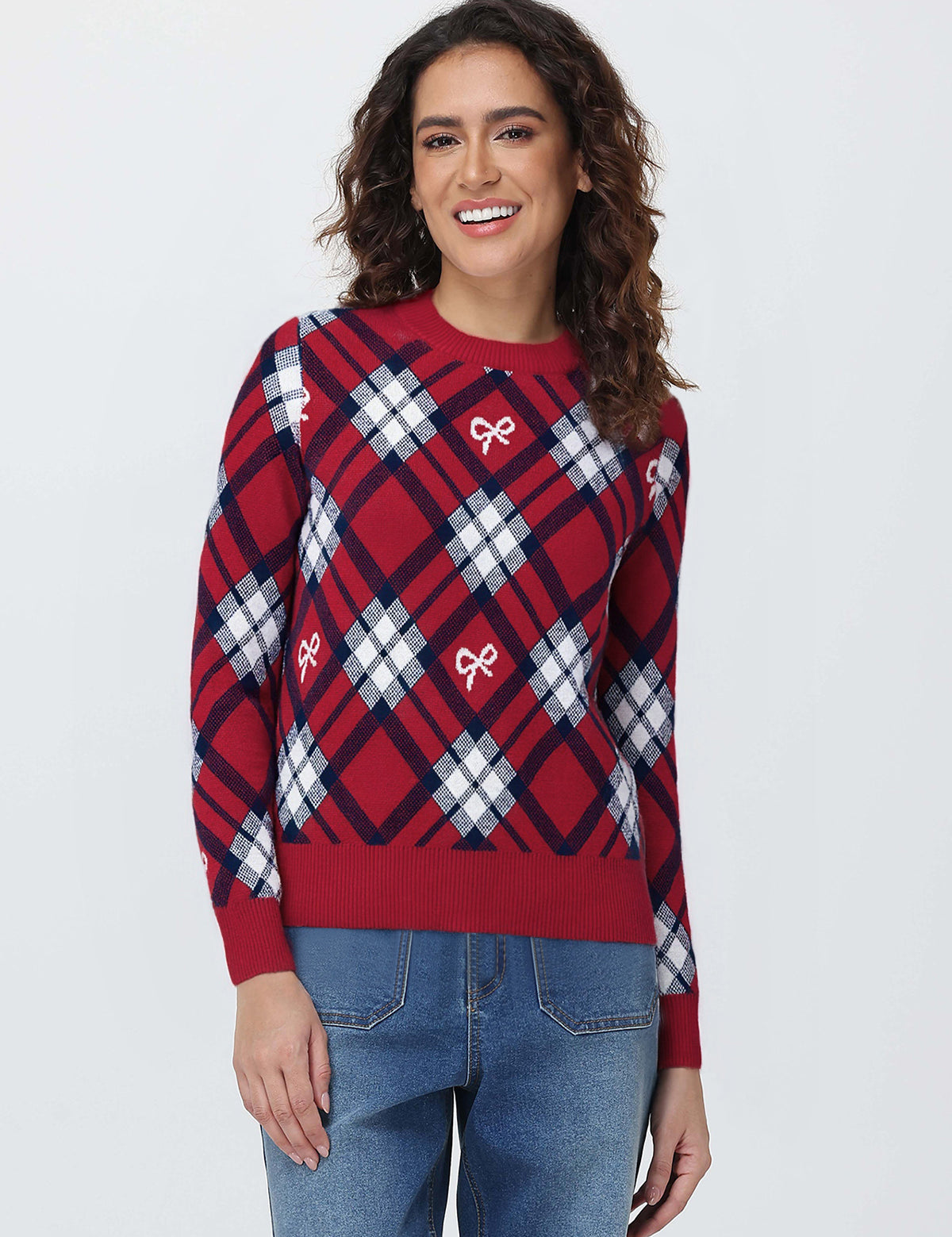 Woman wearing a red and blue plaid sweater with bow designs on a white background