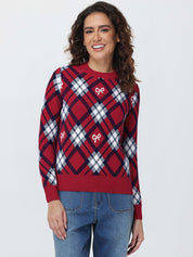 Woman wearing a red and blue plaid sweater with bow designs on a white background