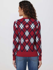 Woman wearing a red and blue plaid sweater with bow designs on a white background