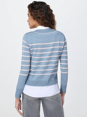 Woman wearing a blue and white striped sweater on a plain background