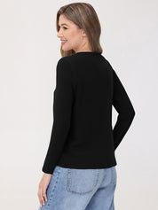 Woman wearing a black top and light blue jeans on a white background