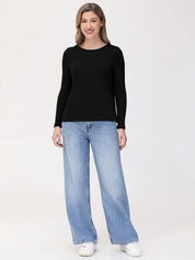 Woman wearing a black long-sleeve top and light blue jeans on a white background