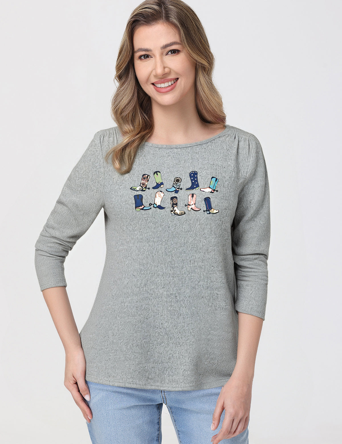 Woman wearing a gray top with cartoon character design on a white background