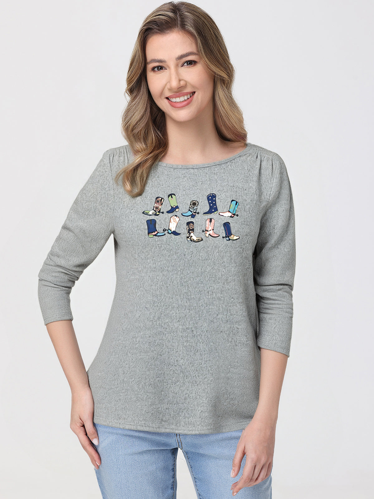 Woman wearing a gray top with cartoon character design on a white background