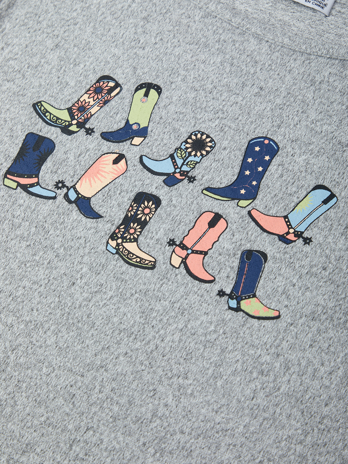Colorful boot designs on a gray fabric background