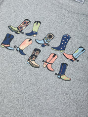 Colorful boot designs on a gray fabric background