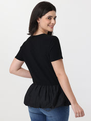 Woman wearing a black peplum top on a white background