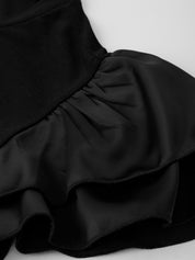 Black fabric with ruffled texture on a white background