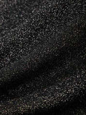 Close-up of black glitter on a black background