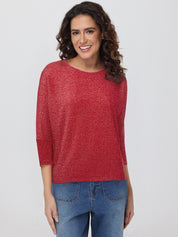 Woman wearing a red tops and blue jeans on a white background