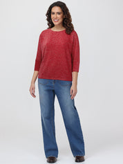 Woman wearing a red tops and blue jeans on a white background