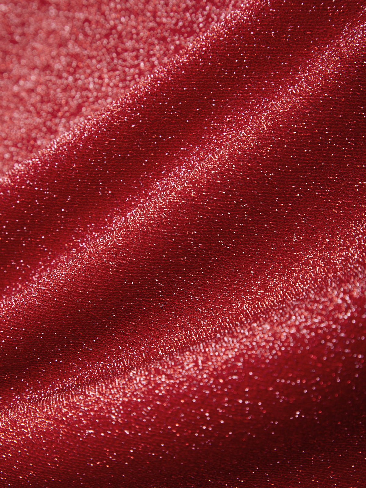 Close-up of red glittery fabric texture