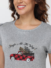 Gray t-shirt with a red truck and 'Jingle All The Way' text design, worn by a person.