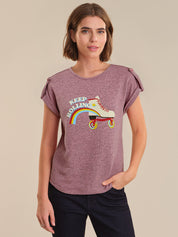 Woman wearing a purple t-shirt with a graphic design on a beige background