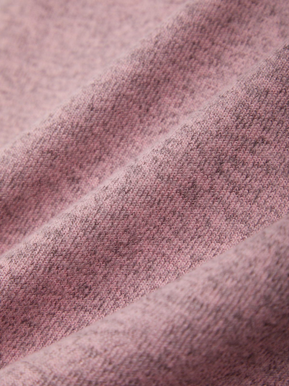 Close-up of a textured pink fabric with a subtle pattern.