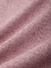 Close-up of a textured pink fabric with a subtle pattern.