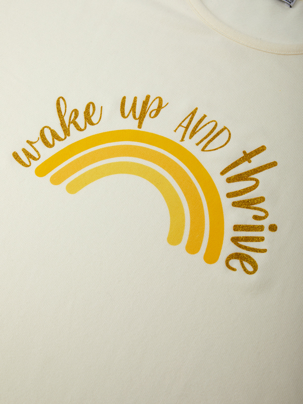 Yellow rainbow with 'wake up and thrive' text on a white background