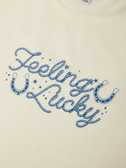 Text 'Feeling Lucky' with blue horseshoe graphics on a beige background