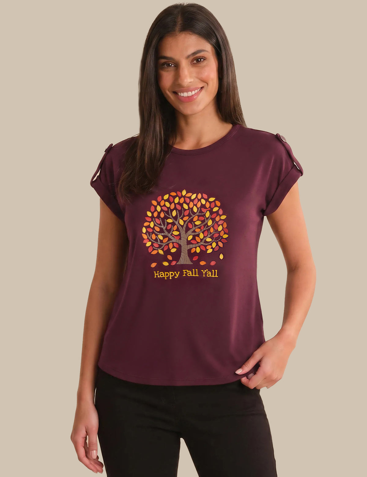 Woman wearing a maroon t-shirt with a tree design and 'Happy Fall Yall' text on a beige background