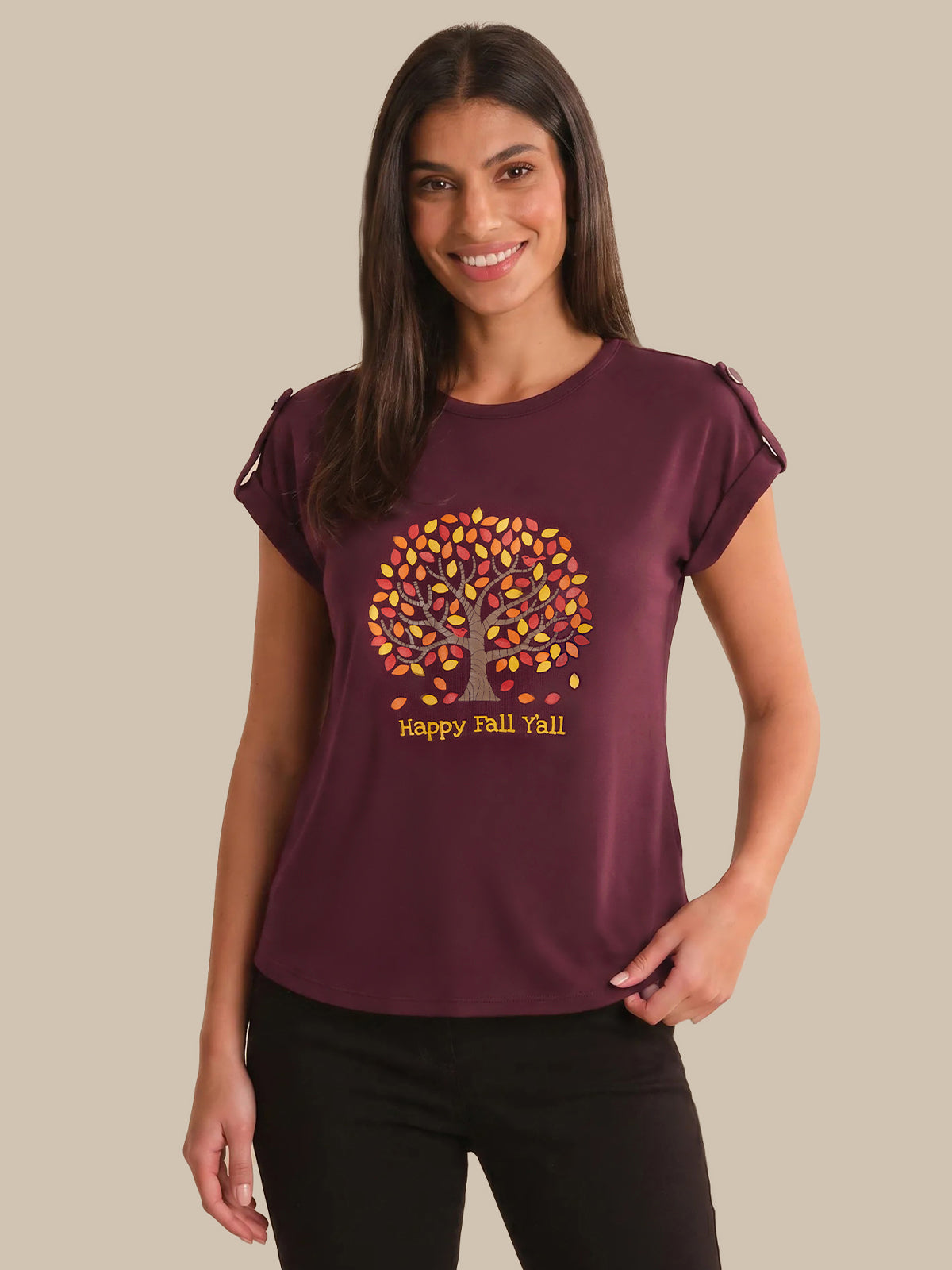 Woman wearing a maroon t-shirt with a tree design and 'Happy Fall Yall' text on a beige background