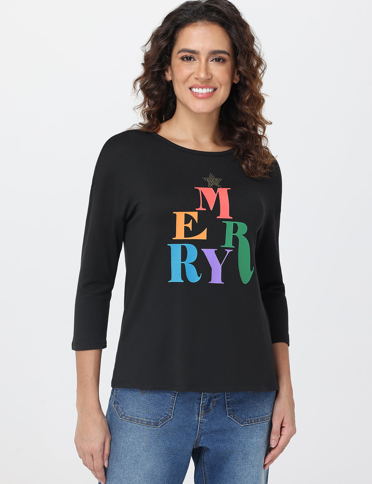 Woman wearing a black long-sleeve shirt with colorful letters spelling 'MERRY' on a white background