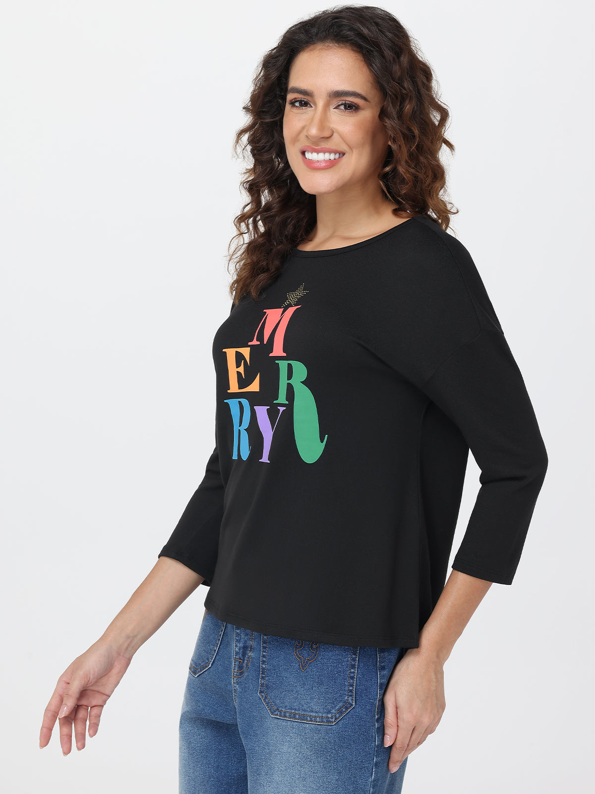 Woman wearing a black top with colorful 'MERRY' text on a white background