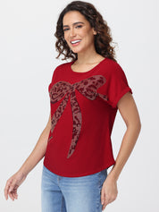 Woman wearing a red t-shirt with a decorative bow design on a white background