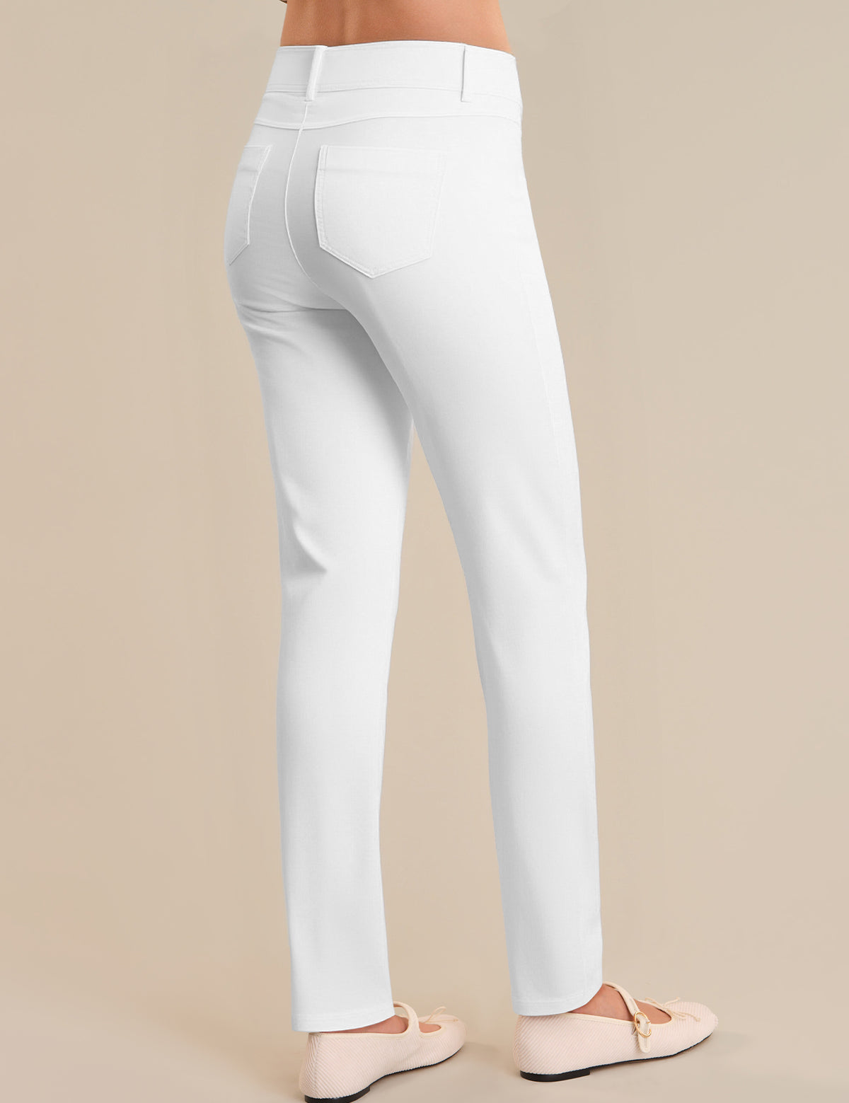 White pants worn by a person on a beige background