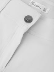 Close-up of a button on a white shirt with '89th Madison' branding.
