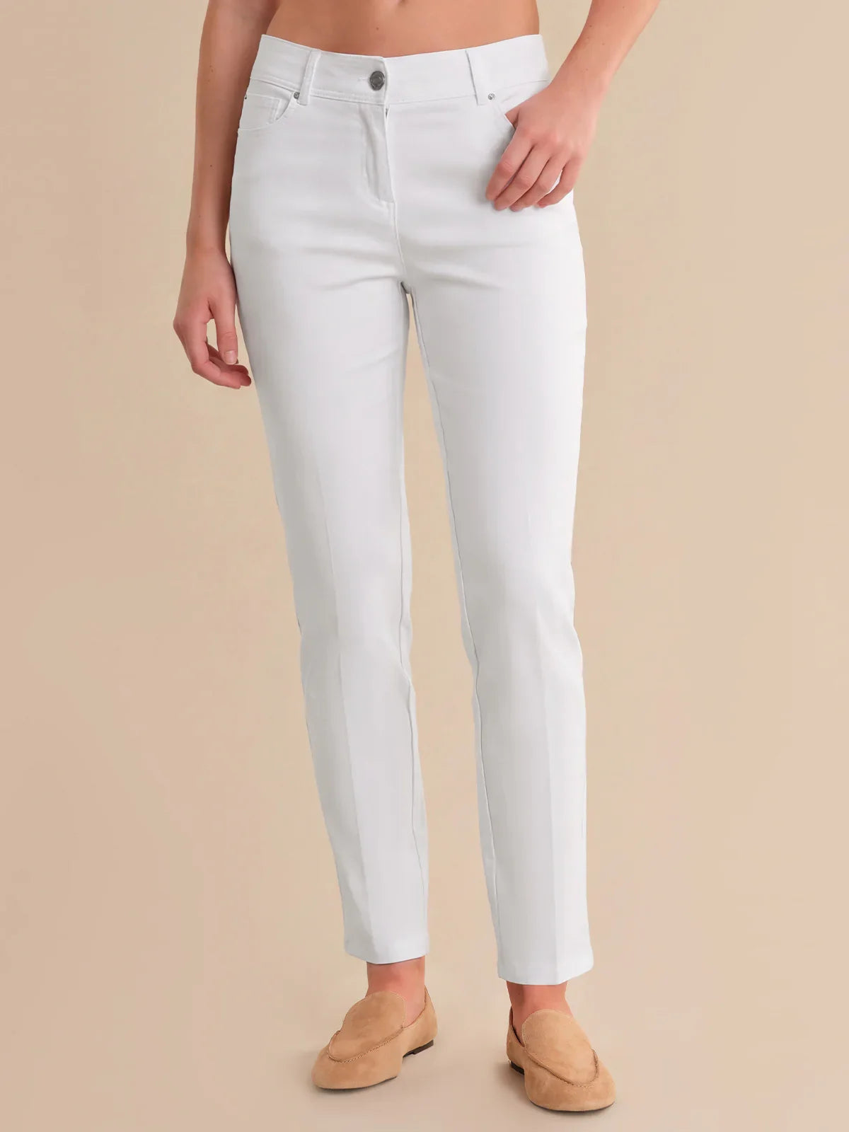 Person wearing white pants on a beige background