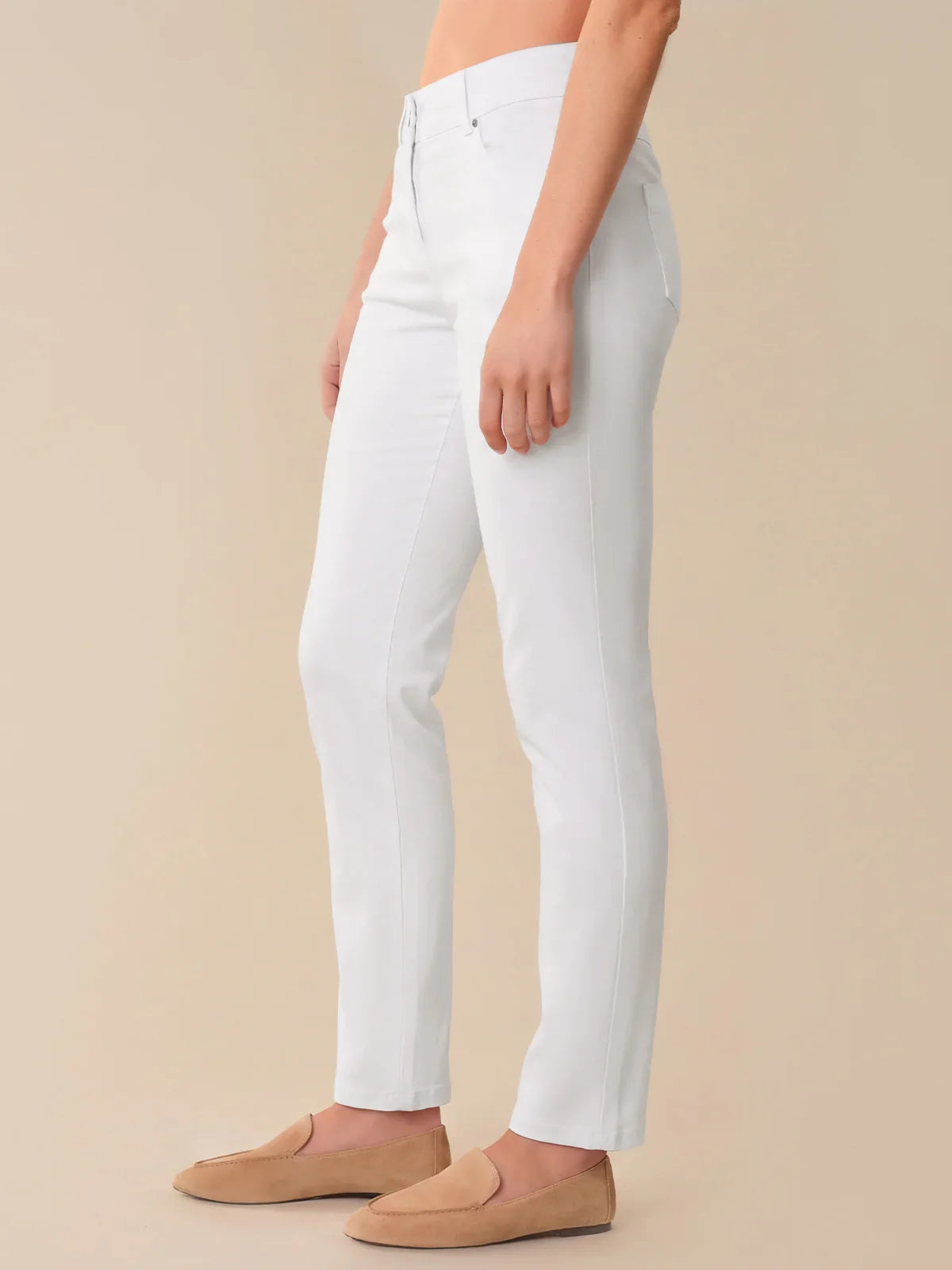 Person wearing white pants on a beige background