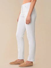 Person wearing white pants on a beige background
