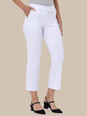 White cropped ankle-length pants with front patch pockets, shown on a model wearing a gray top and black heeled sandals against a beige studio background.