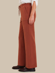 Red wide-leg pants worn by a person on a beige background