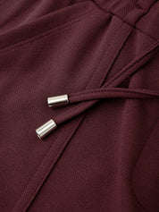 Close-up of a burgundy fabric with metal buttons