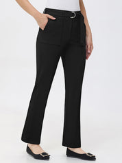 Black pants with a belt worn by a person on a white background