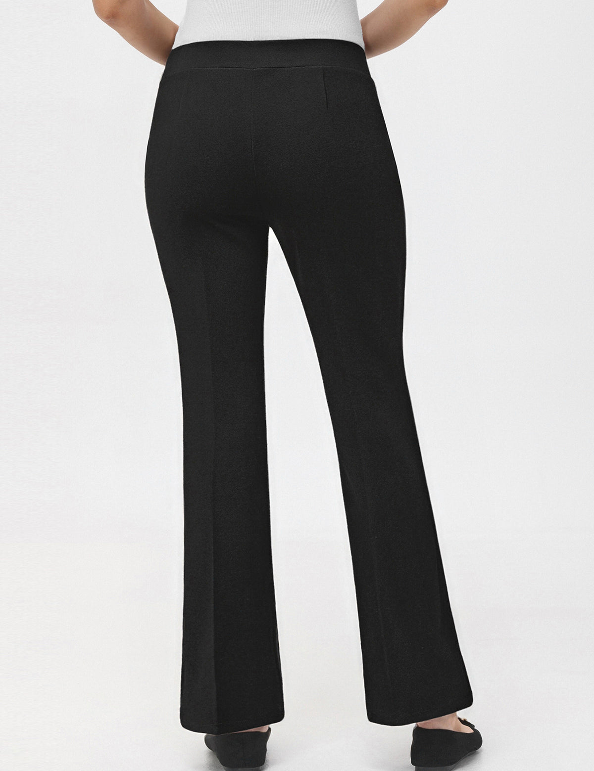 Black pants worn by a person on a white background