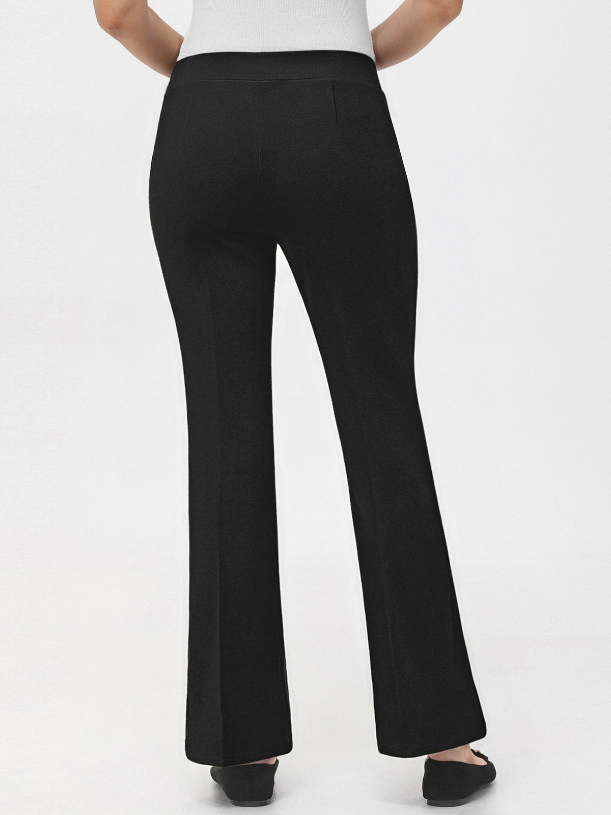 Black pants worn by a person on a white background