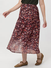 Person wearing a floral skirt on a white background