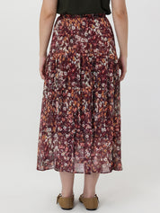 Person wearing a floral skirt on a white background