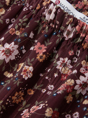 Close-up of a floral skirt with a brand tag in the background