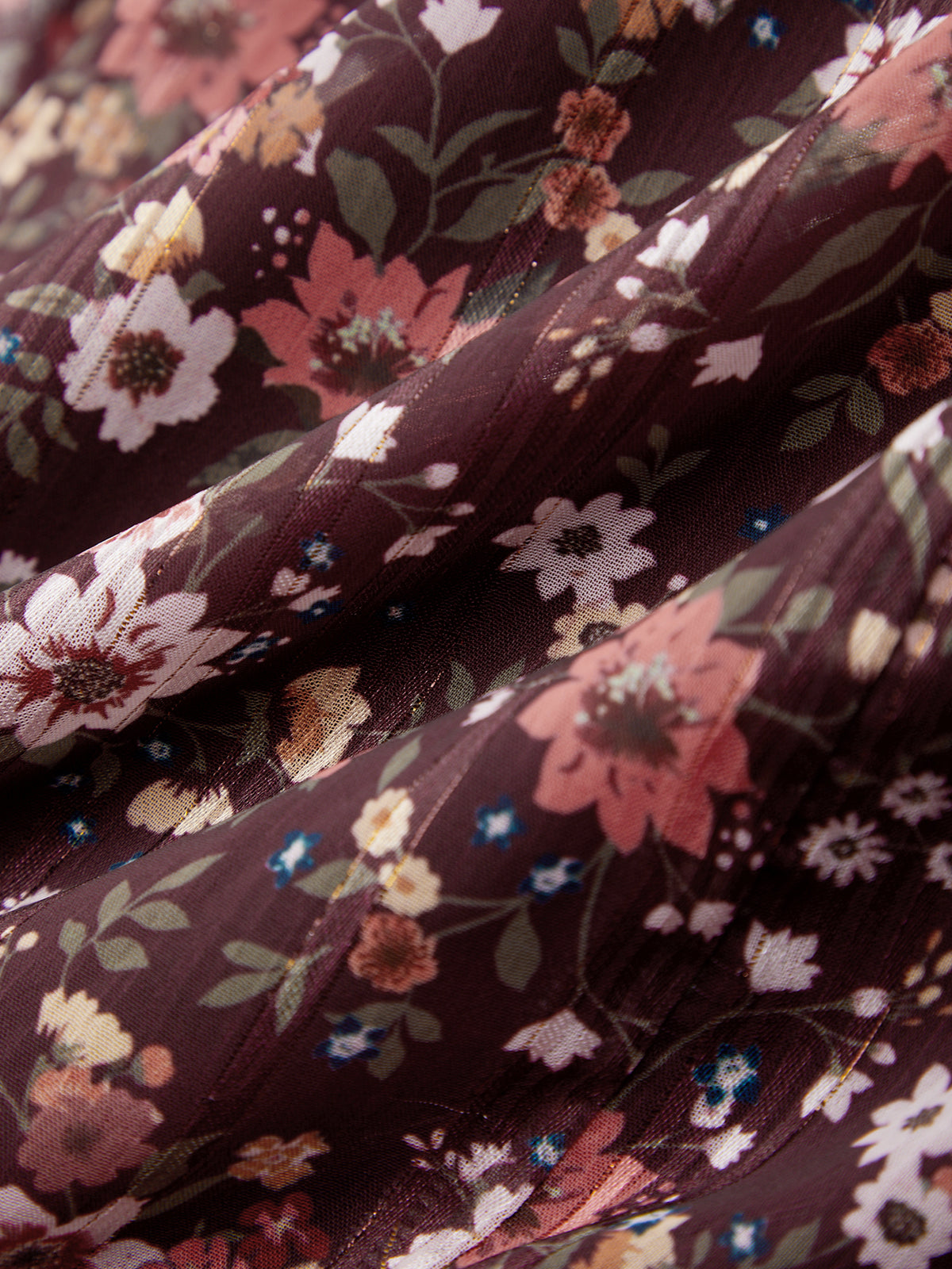 Close-up of floral fabric with a dark brown background