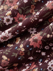 Close-up of floral fabric with a dark brown background