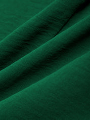 Close-up of dark green fabric with folds