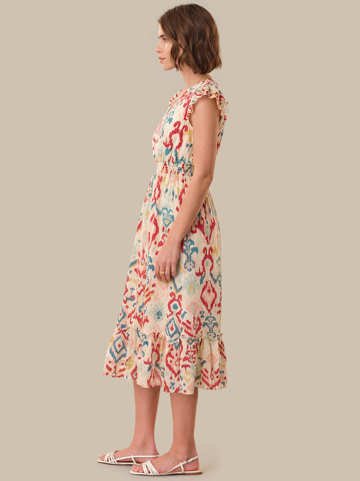 Woman wearing a floral dress on a beige background