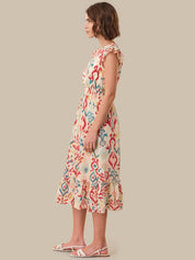 Woman wearing a floral dress on a beige background