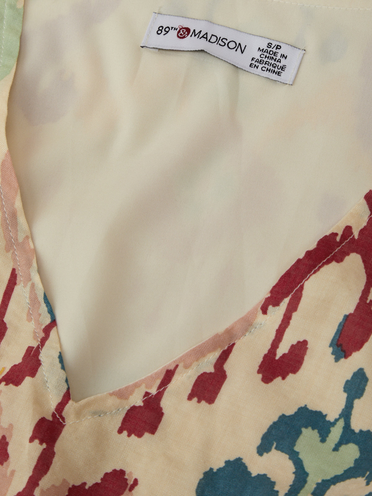 Close-up of a fabric with a colorful pattern and a 'Madison' label.