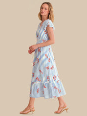 Woman wearing a blue and white striped dress with floral patterns on a beige background