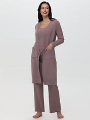 Woman wearing a mauve loungewear set on a white background